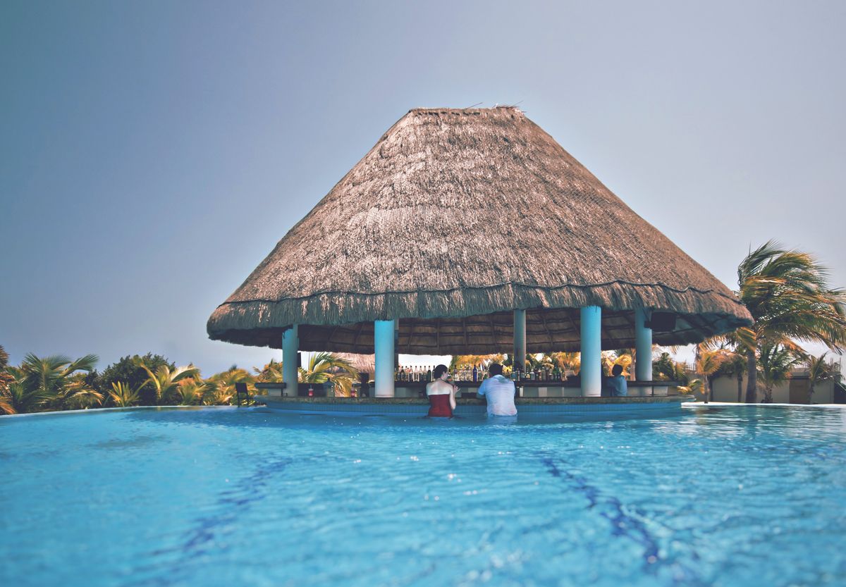 Guests being served at a swim-up pool bar