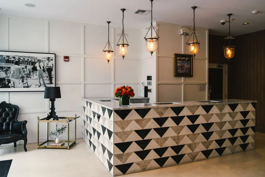 Hotel reception desk with pendant lights and flowers